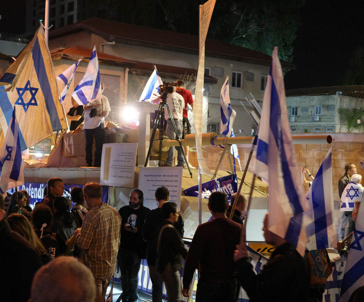 Military Veterans protest with a cardboard tank.